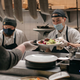 cook handing food to server
